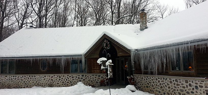 A home with ice dams and heavy icicle formation